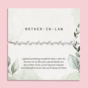 pink background with mother in law poem card with green design and silver-plated vine bracelet