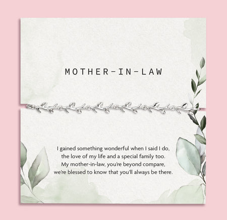 pink background with mother in law poem card with green design and silver-plated vine bracelet