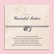 A silver beaded bracelet with a heart and flower charm displayed on a card reading "To my Wonderful Mother" from Letterbox Love, set against a soft pink background. The card features a heartfelt poem, making it a perfect sentimental gift for a mother
