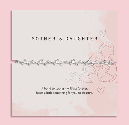 a pale pink background with mother and daughter poem card with a silver-plated vine bracelet