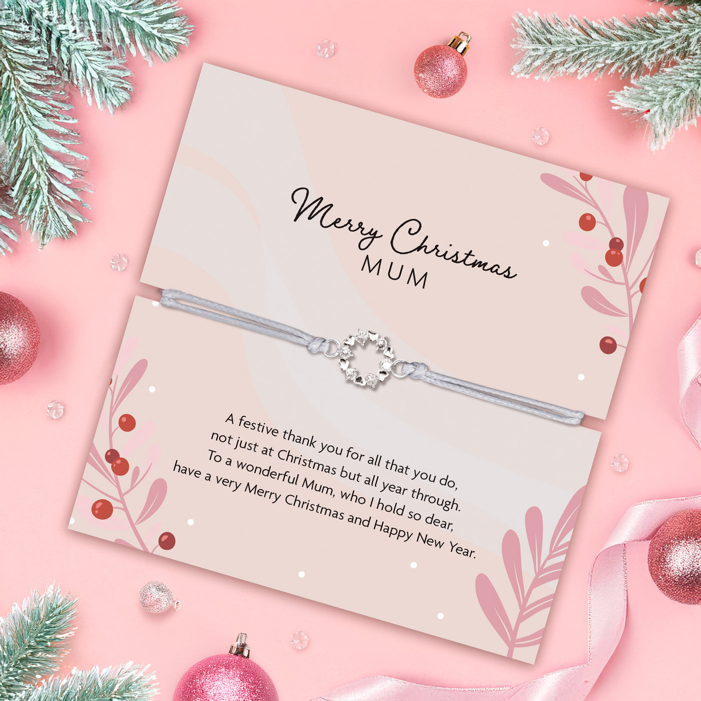 Mum Christmas gift with a bracelet and festive decorations on a pink background. Beautiful wreath bracelet for under £20