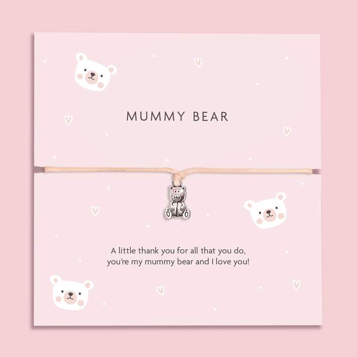 A soft pink bracelet card with a cute teddy bear charm, featuring the text "MUMMY BEAR" and a heartfelt message, "A little thank you for all that you do, you're my mummy bear and I love you!" surrounded by adorable bear illustrations.