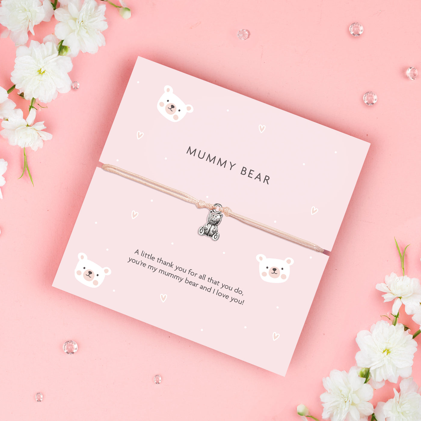 A soft pink bracelet card with a cute teddy bear charm, featuring the text 