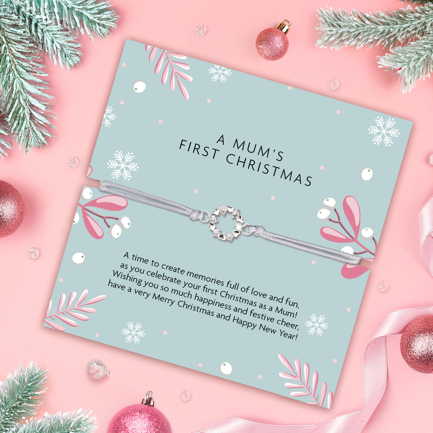 Poem card and elegant bracelet for a mum's first Christmas with decorative elements on a pink background