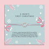 Delicate silver charm bracelet on a festive card, a sentimental gift celebrating a mum’s first Christmas.