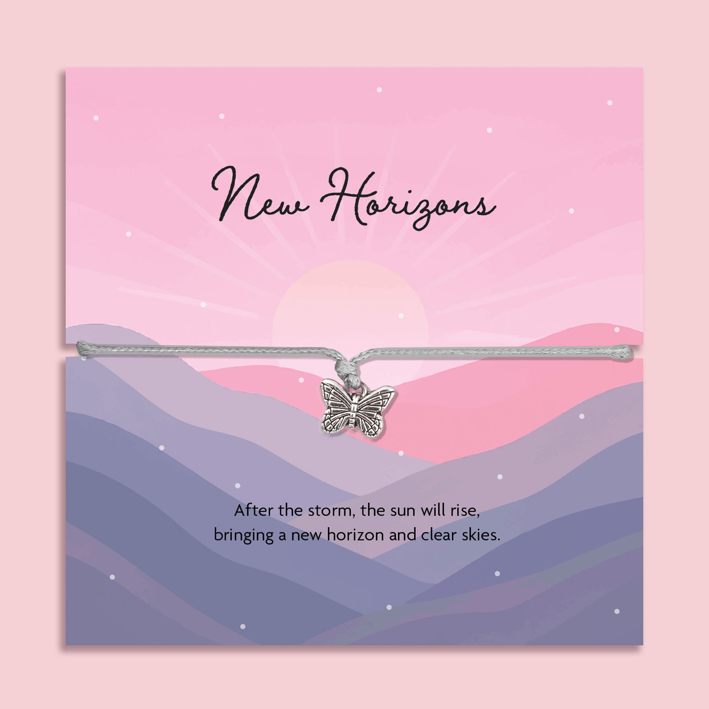 Butterfly charm bracelet on a card with 'New Horizons' text and mountain landscape design.