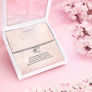 Silver beaded bracelet with heart and flower charms, presented in a white gift box with a card titled "To My Lovely Niece." The card features a heartfelt message celebrating a niece’s uniqueness and encouraging her to chase her dreams.