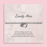 A silver beaded bracelet with a heart and flower charm displayed on a card reading "To my Lovely Niece" from Letterbox Love, set against a soft pink background. The card includes a heartfelt poem, making it a perfect sentimental gift for a Niece.