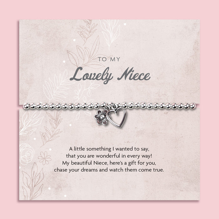 A silver beaded bracelet with a heart and flower charm displayed on a card reading "To my Lovely Niece" from Letterbox Love, set against a soft pink background. The card includes a heartfelt poem, making it a perfect sentimental gift for a Niece.