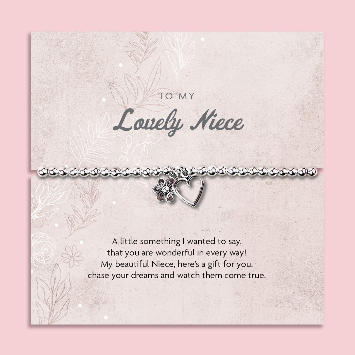 A silver beaded bracelet with a heart and flower charm displayed on a card reading 
