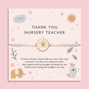 White adjustable cord bracelet with a gold and white enamel daisy charm, displayed on a soft pink thank you card that reads 'Thank You Nursery Teacher'. Surrounded by cute illustrations of a sun, cloud, elephant, and koala, with a heartfelt poem. A thoughtful end-of-term gift by Letterbox Love.