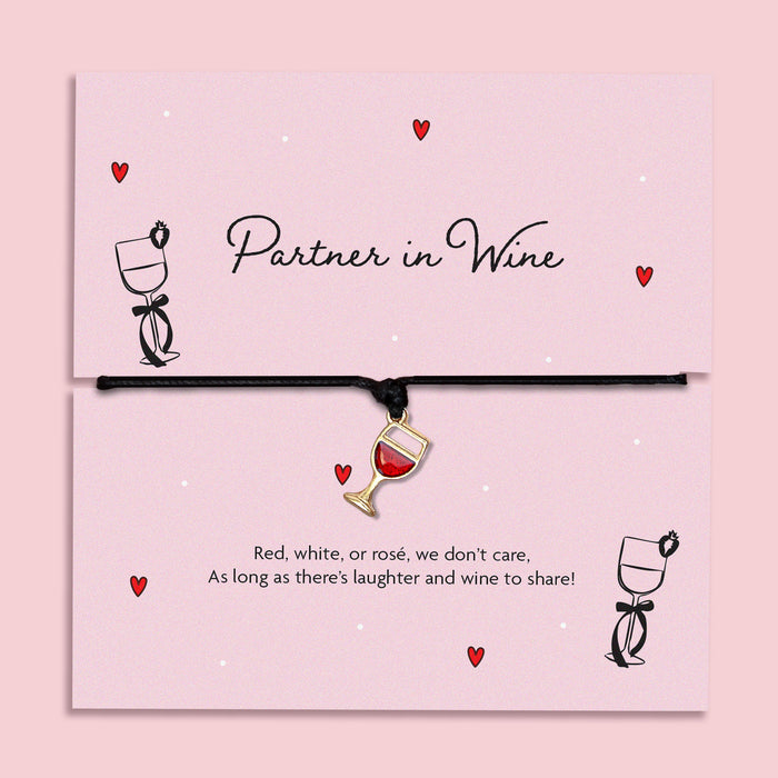 Partner in Wine bracelet featuring a red wine glass charm on a black cord, presented on a fun, illustrated card with a playful sentiment for wine lovers. A fun friendship bracelet for best friends.