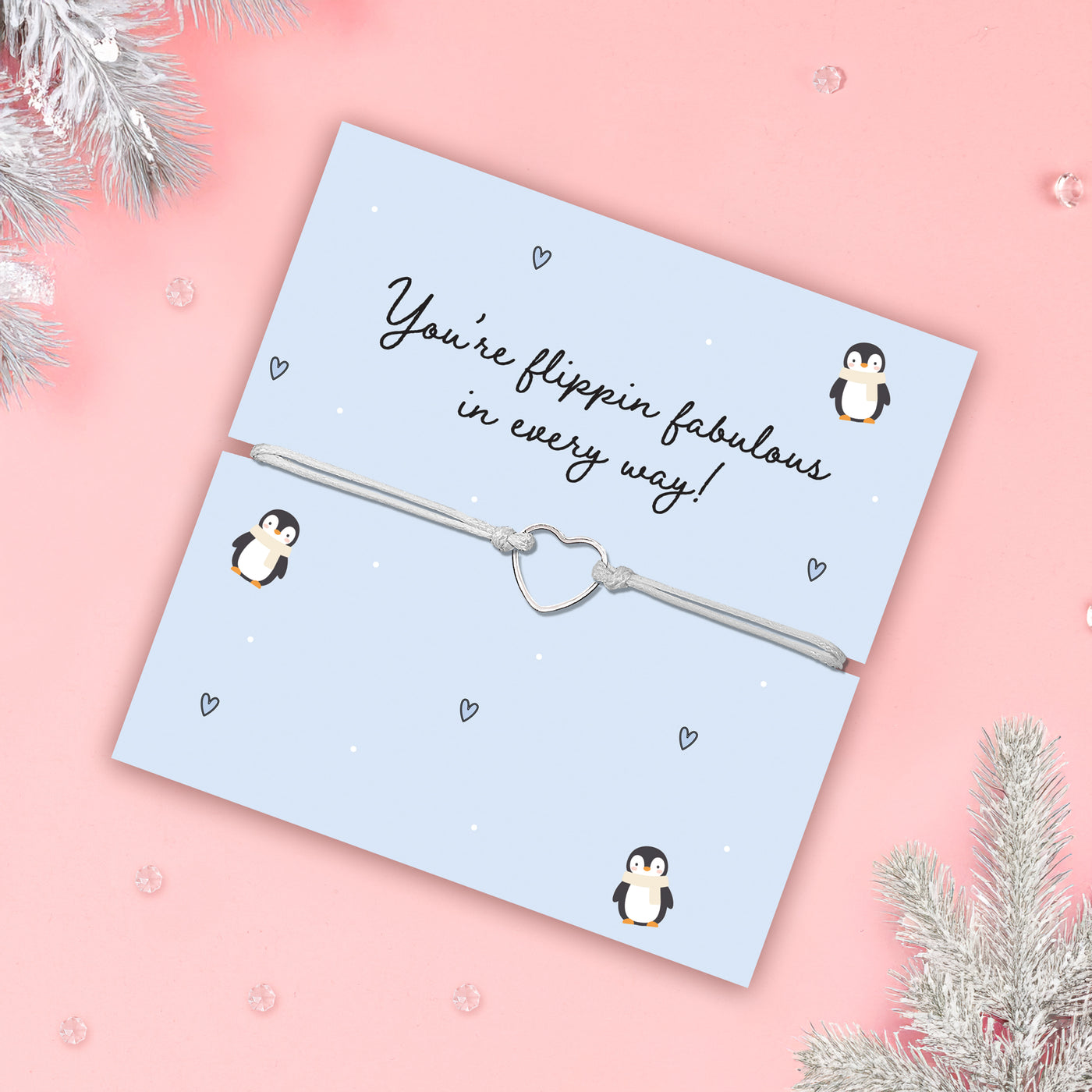 Jewellery card with penguin design and message on a pink background