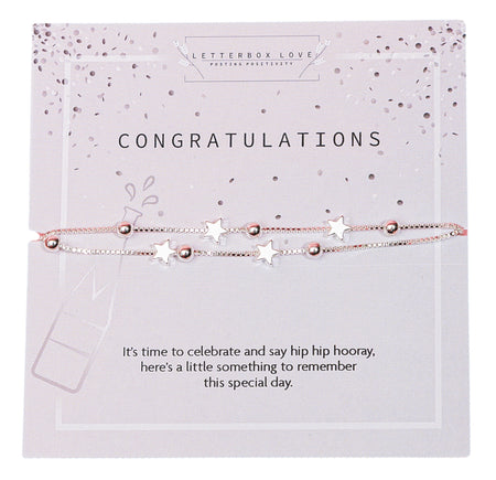 A celebratory 'CONGRATULATIONS' bracelet with silver stars and rose gold beads on a card featuring champagne and confetti graphics, along with a message for commemorating a special occasion