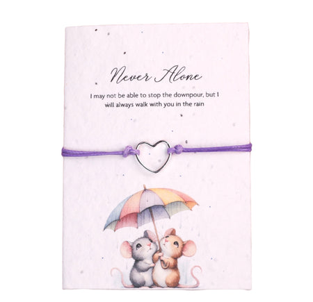 A gift set featuring a plantable greeting card with an illustration of two mice under a multicolored umbrella and the phrase 