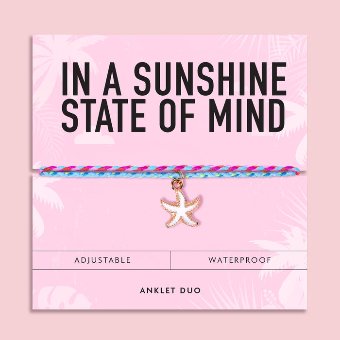 Colourful waterproof anklet duo featuring pink and turquoise woven cords with a white starfish charm on a pink "In A Sunshine State Of Mind" gift card. Perfect summer beach jewellery and holiday accessory.