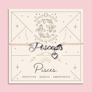 Adjustable peach cord bracelet with a silver 'Pisces' charm and small heart pendant, displayed on a zodiac-themed backing card with a fish illustration and traits reading "Intuitive, Gentle, Empathetic".