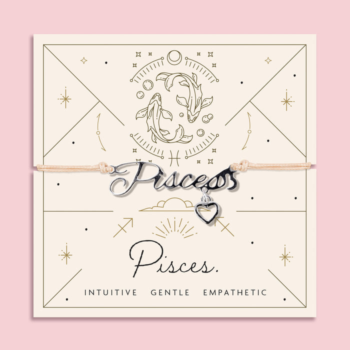 Adjustable peach cord bracelet with a silver 'Pisces' charm and small heart pendant, displayed on a zodiac-themed backing card with a fish illustration and traits reading "Intuitive, Gentle, Empathetic".