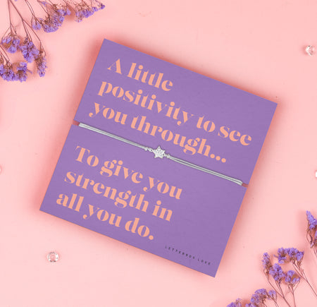 A lavender-colored bracelet card titled 