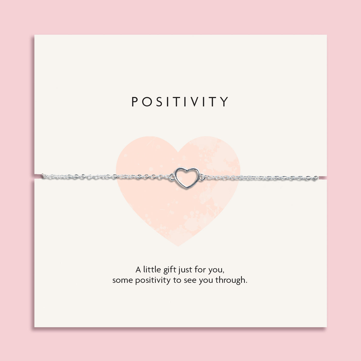 Elegant silver heart-shaped necklace on a 'POSITIVITY' card with the message 'A little gift just for you, some positivity to see you through.