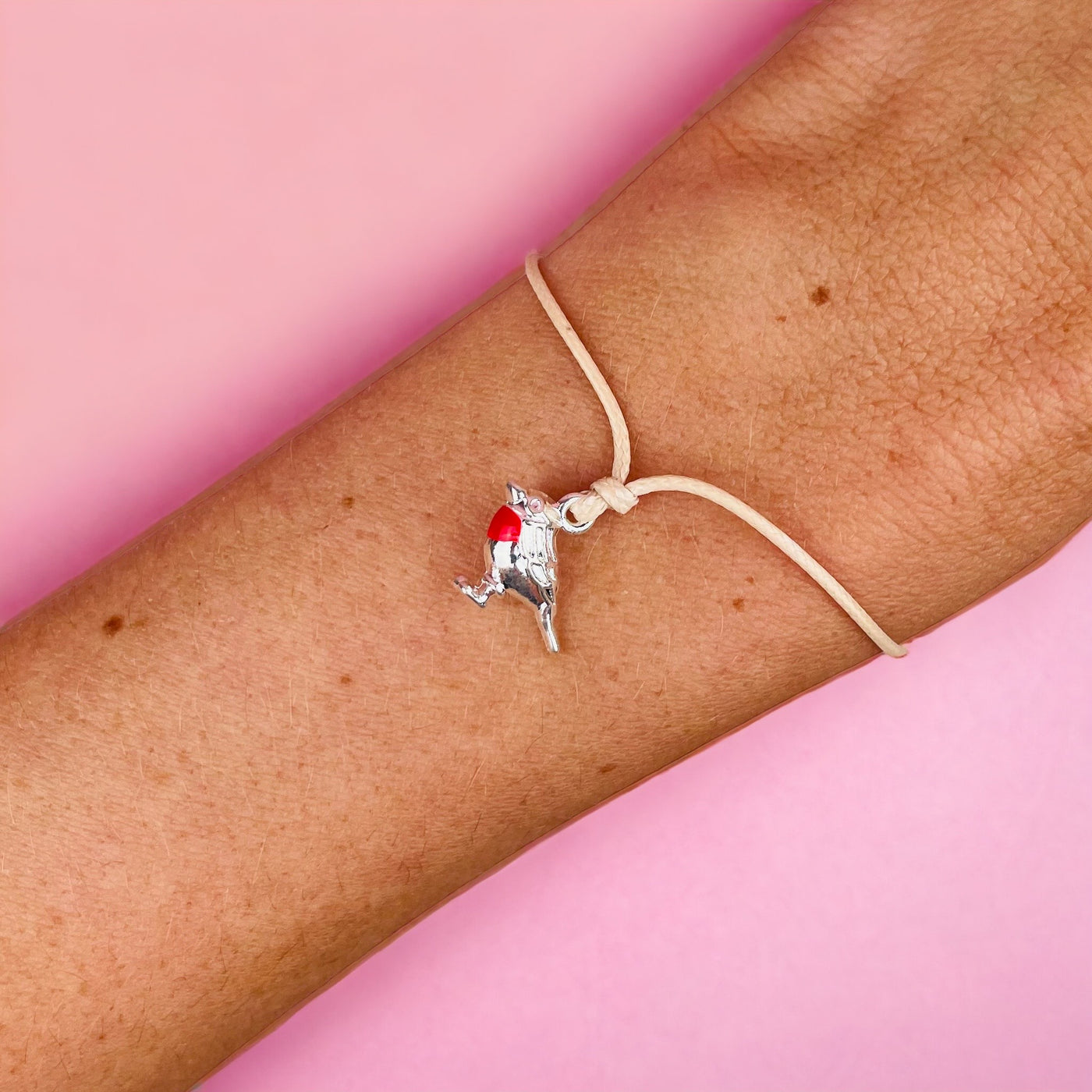 A woman wearing a bracelet with a cute Christmas robin charm. The robin bracelet is a perfect Xmas gift for an animal.