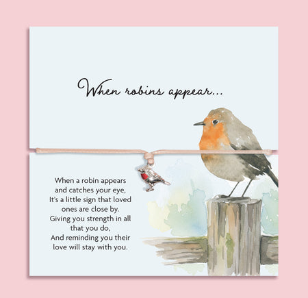 Adjustable sympathy bracelet with a silver robin charm on a blush cord, displayed on an illustrated keepsake card reading 
