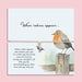 Adjustable sympathy bracelet with a silver robin charm on a blush cord, displayed on an illustrated keepsake card reading 