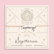 Meaningful Sagittarius bracelet with zodiac design on a pink background. A cute friendship bracelet for Sagittarius star sign.