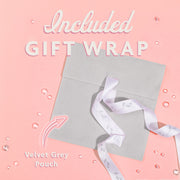 Grey velvet pouch with a white ribbon on a pink background, labeled 'Included Gift Wrap'. Zodiac bracelet free gift wrapping. Sagittarius present for a friend.