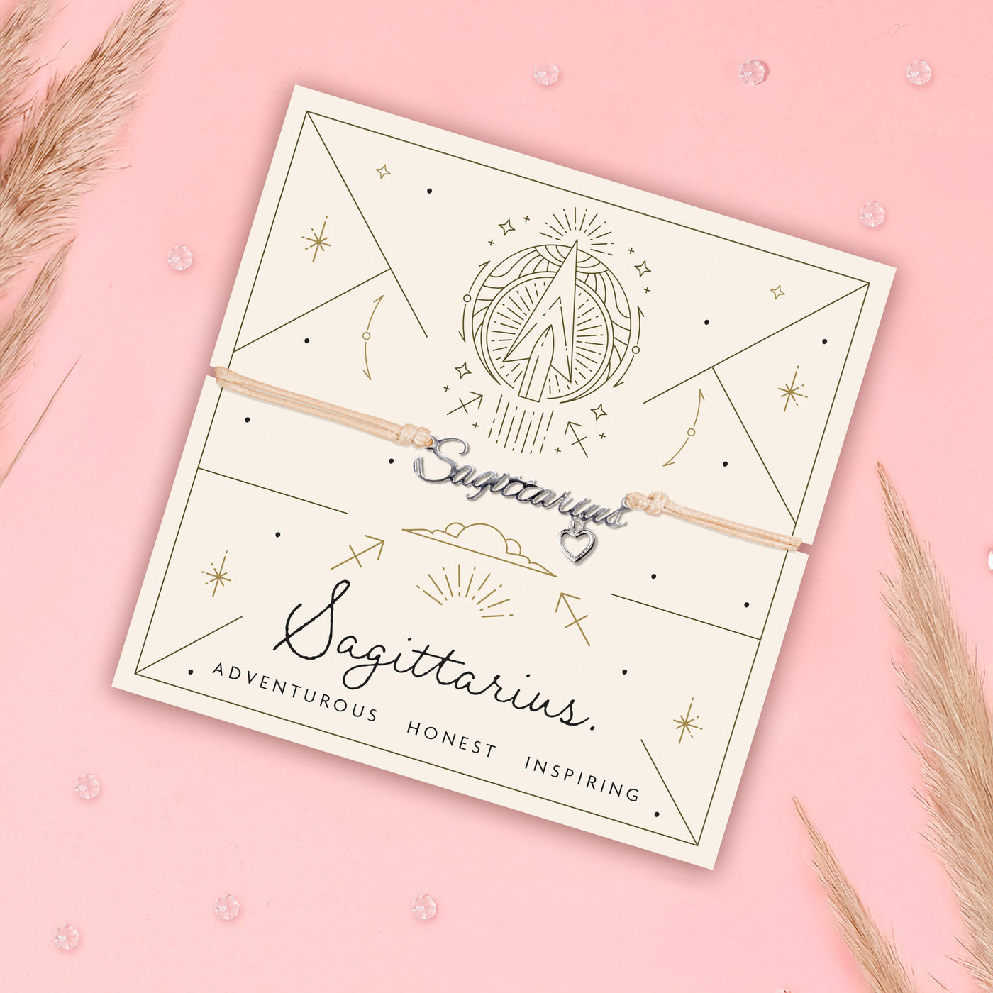 Sagittarius-themed bracelet on a branded card with decorative elements on a pink background. Star sign jewellery for women under £20