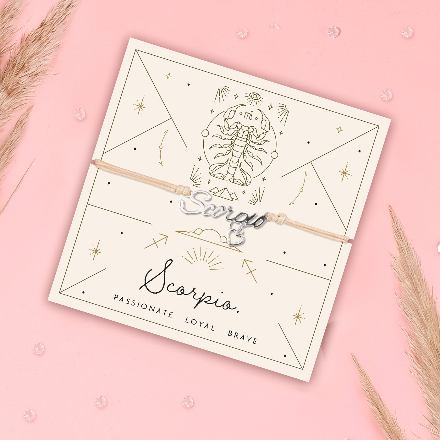Scorpio zodiac bracelet on a matching card with decorative elements on a pink background. Scorpio bracelet for a friend