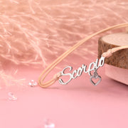 Necklace with 'Scorpio' pendant on a pink background. Zodiac bracelet for women, scorpio birthday gift