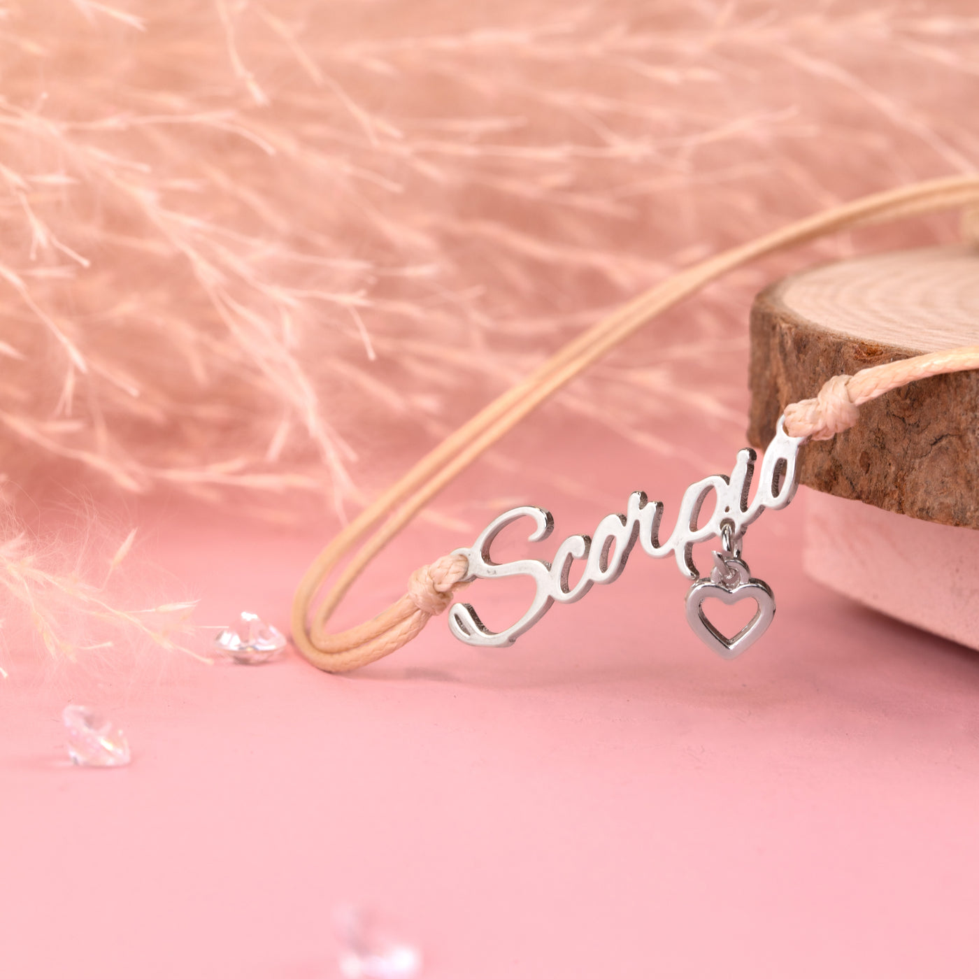 Necklace with 'Scorpio' pendant on a pink background. Zodiac bracelet for women, scorpio birthday gift