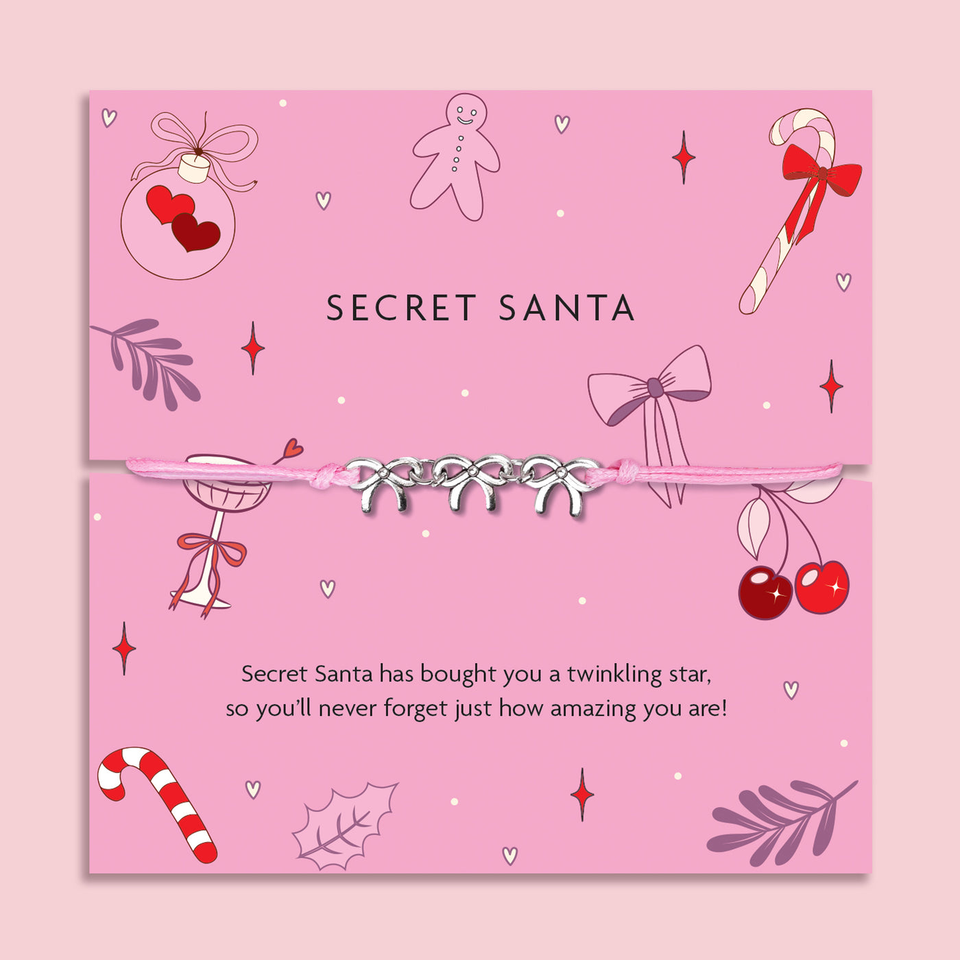 Pink Secret Santa card with decorative elements and a pink friendship bracelet on a pink background