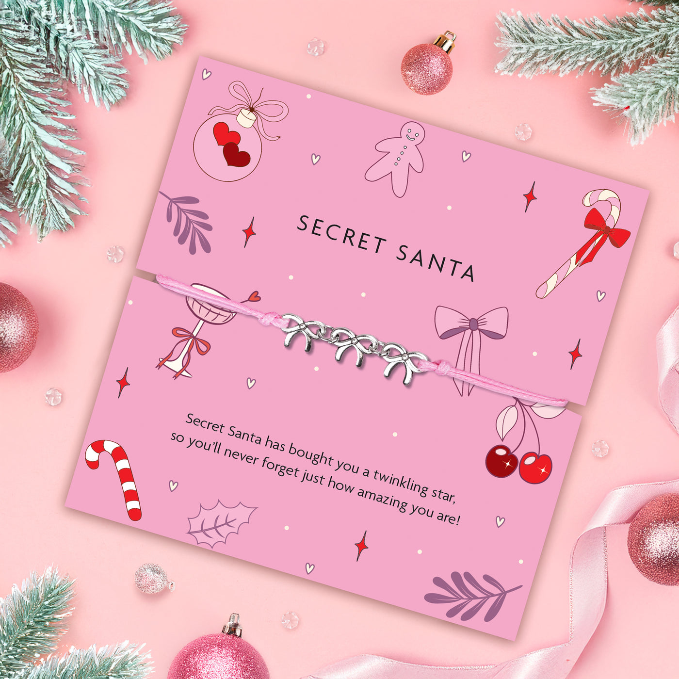 Pink 'Secret Santa' card with Christmas-themed illustrations on a pink background with festive decorations. Secret Santa gift under £10.