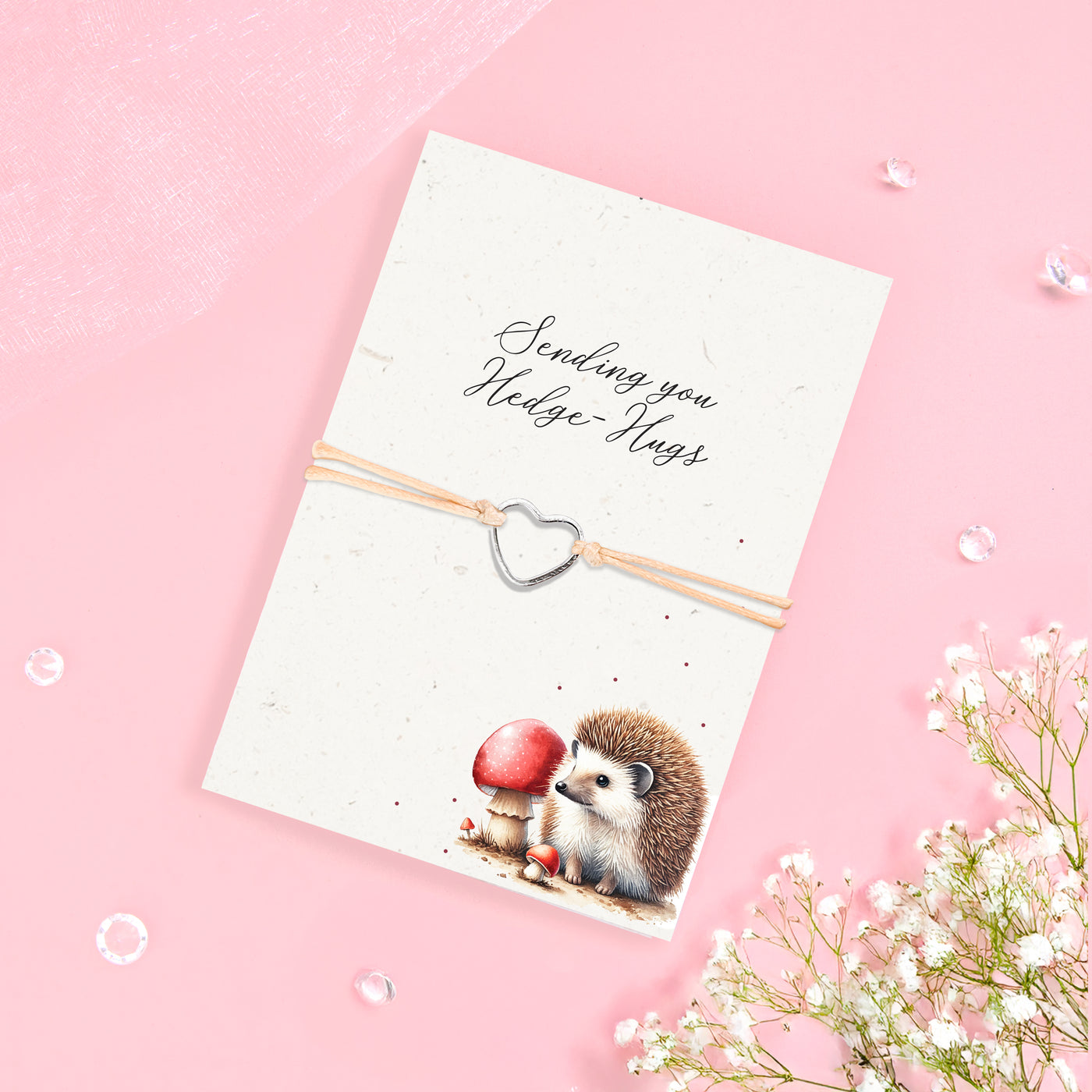Silver heart charm bracelet with eco-friendly seeded card featuring a hedgehog illustration and the sentiment 