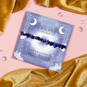 Lapis Lazuli Serenity Stones bracelet featuring blue crystal chips, placed on a celestial-themed card with the words "Serenity Stones" and a message about guiding through truth and honesty.