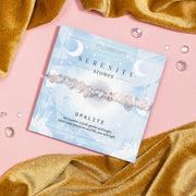 Serenity Stones Opalite crystal bracelet with smooth opalite beads on a celestial-themed card, offering good energy, calmness, and emotional healing. Perfect gift for mindfulness, spiritual wellness, and crystal healing enthusiasts