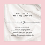 Card with heart-shaped bracelet and 'Will You Be My Bridesmaid?' message on a pink background. A beautiful gift for a bridal party or bridesmaid boxes.