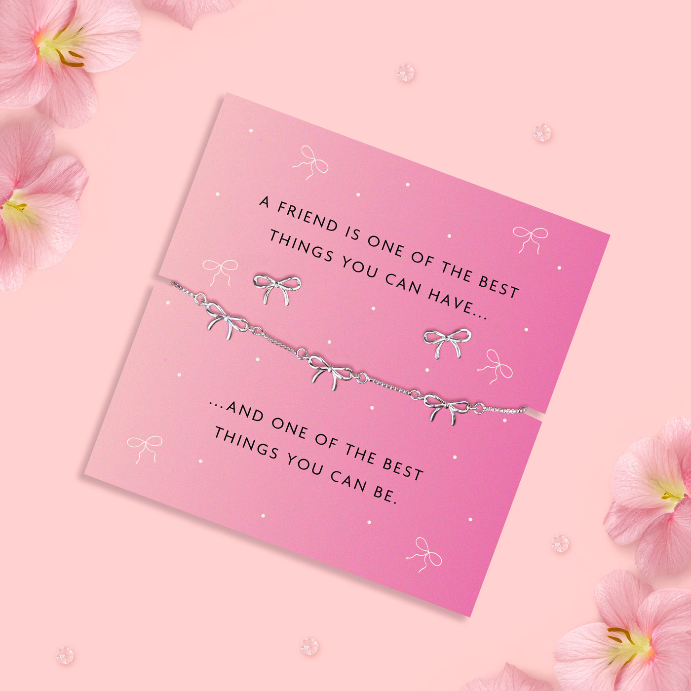 Silver-plated brass bow bracelet and earrings set, featuring delicate bow charms, presented on a pink card with a heartfelt sentiment about friendship.