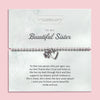 Silver beaded bracelet with heart and flower charms, displayed in a white gift box alongside a card titled 