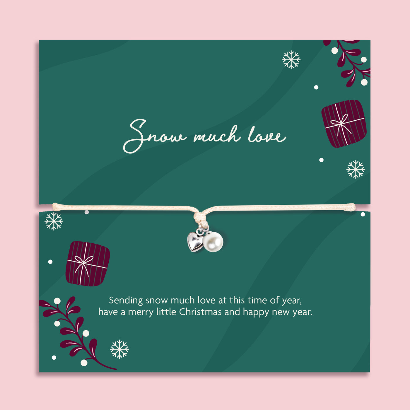 A delicate silver bracelet with a small pearl and silver heart charm is displayed on a festive dark green card. The card features Christmas illustrations, including snowflakes, wrapped gifts, and evergreen branches, along with the text 'Snow much love' and a holiday message.