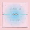 Something Blue wedding bracelet with silver-plated star charm and cubic zirconia on pale blue cord, displayed on a pink poem card.