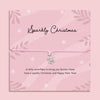 Delicate silver snowflake charm bracelet on a pink cord, displayed on a pink “Sparkly Christmas” poem card with festive snowflake design, thoughtful Christmas gift for her by Letterbox Love.