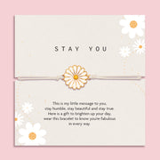 Letterbox Love 'Stay You' daisy bracelet gift – white and gold enamel daisy charm on a neutral cord, presented on a positive message card with floral design. A thoughtful and uplifting jewellery gift for her, perfect for friendship, self-love, encouragement or just because. Ideal letterbox gift to brighten someone’s day.