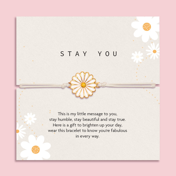 Letterbox Love 'Stay You' daisy bracelet gift – white and gold enamel daisy charm on a neutral cord, presented on a positive message card with floral design. A thoughtful and uplifting jewellery gift for her, perfect for friendship, self-love, encouragement or just because. Ideal letterbox gift to brighten someone’s day.