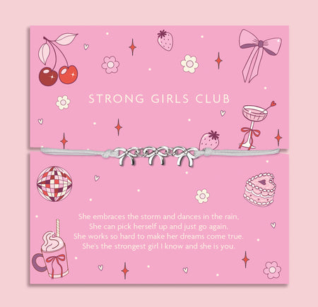 Pink card with 'Strong Girls Club' text and a bracelet on a pink background