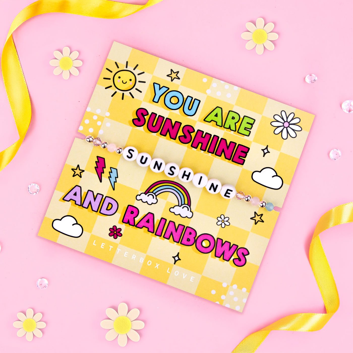 An image of a cheerful motivational card featuring a beaded bracelet with the word 