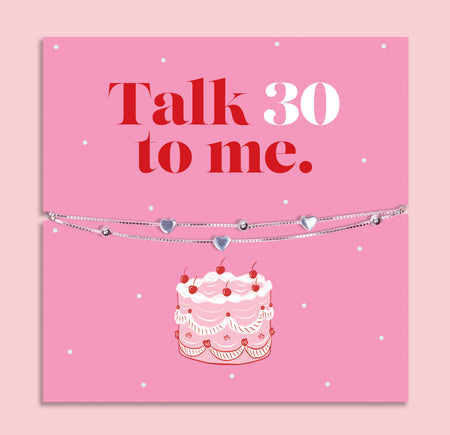 925 sterling silver bracelet with small heart charms displayed on bright pink Talk 30 to Me birthday card, fun 30th birthday jewellery gift for her.