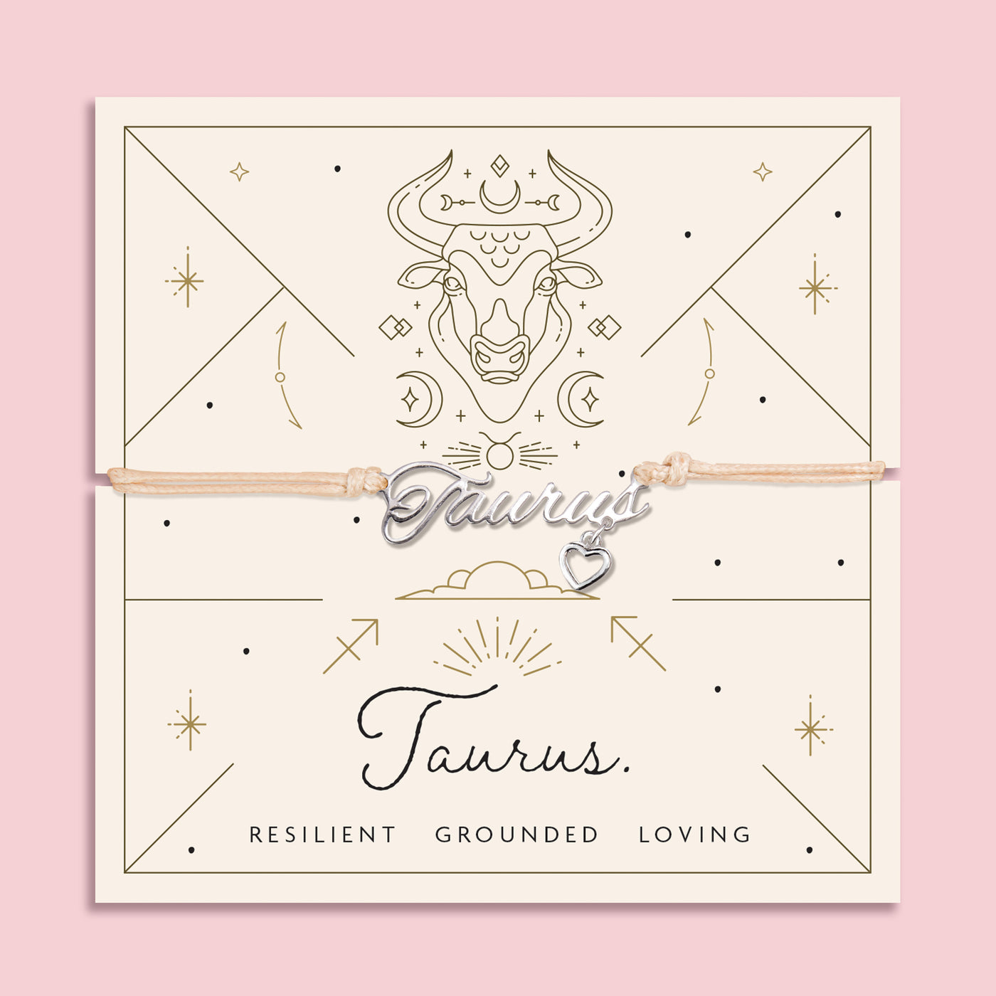 Adjustable peach cord bracelet with a silver 'Taurus' charm and heart pendant, displayed on a zodiac-themed backing card with a bull illustration and traits reading 